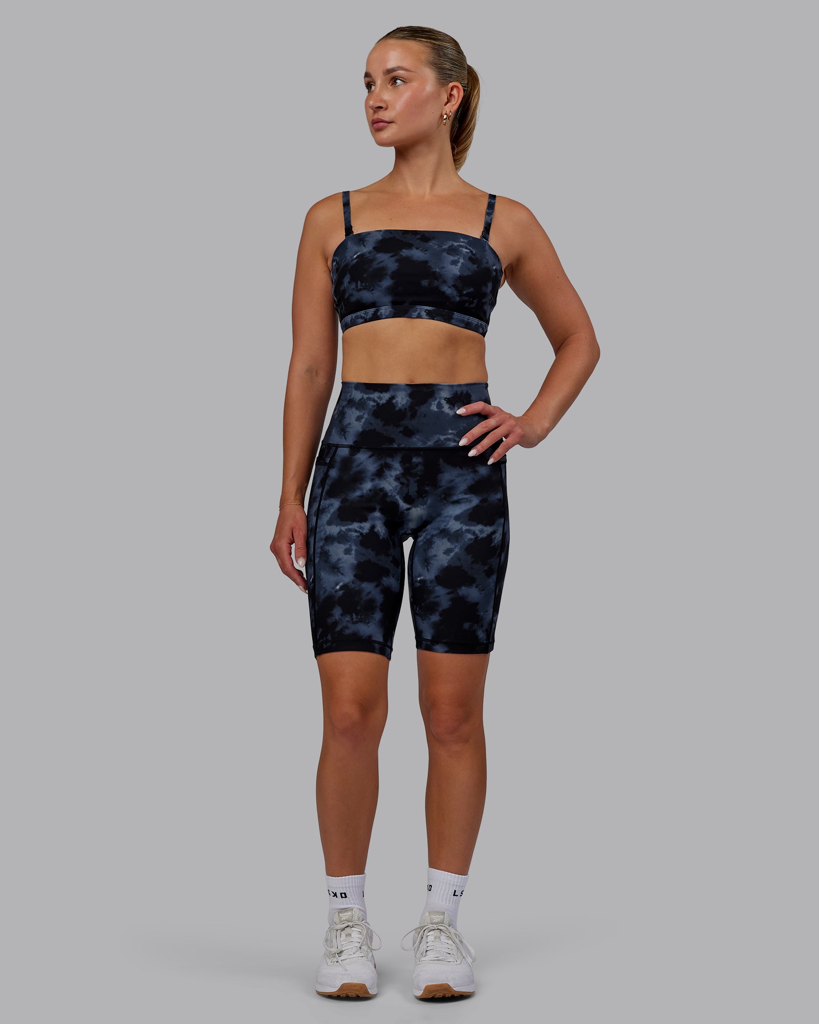 Woman wearing Fusion Ultra High-Rise 9" Short Pockets - Tie Dye-Midnight | Model:Halle | Size:S