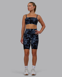 Woman wearing Fusion Ultra High-Rise 9" Short Pockets - Tie Dye-Midnight | Model:Halle | Size:S