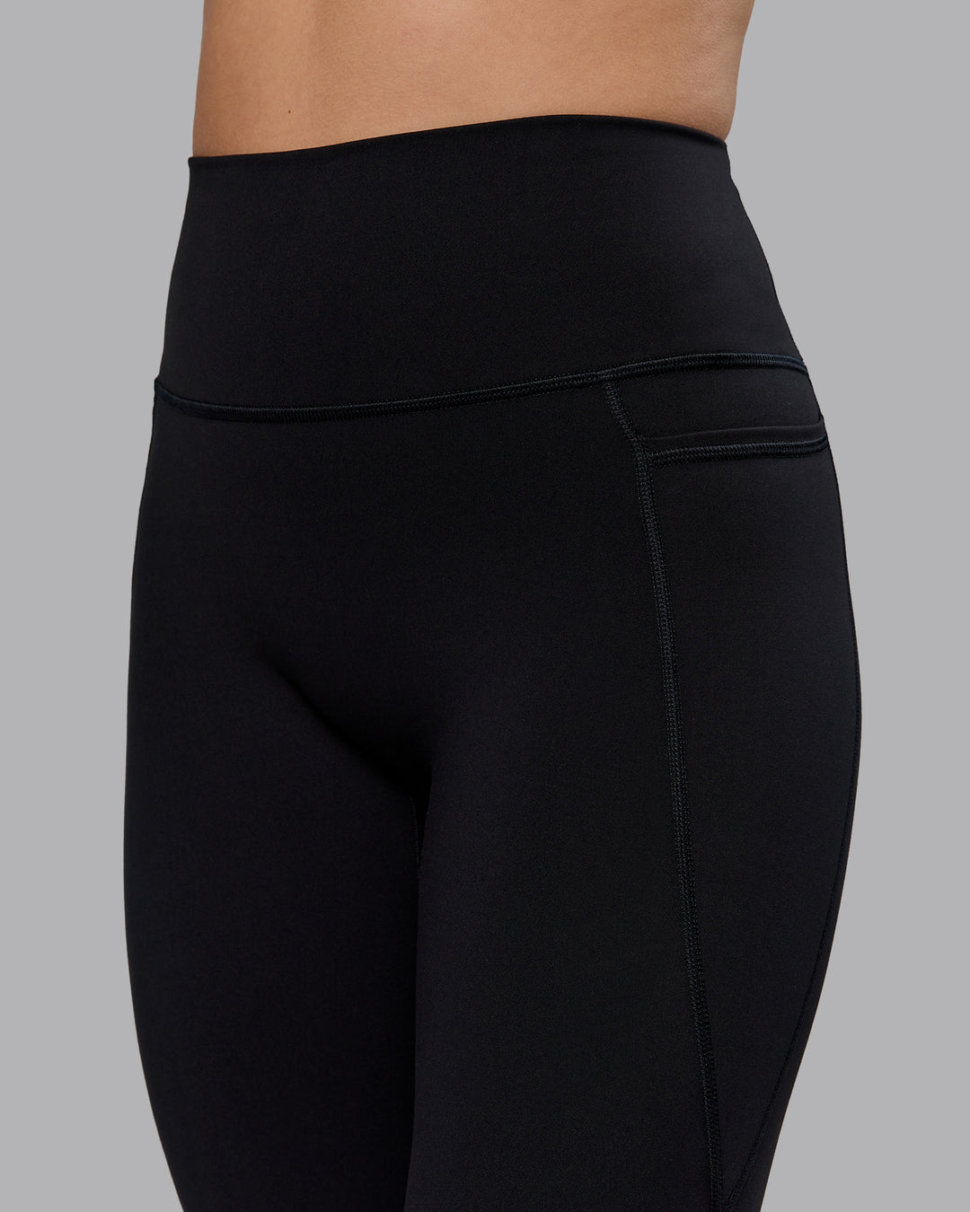 Woman wearing Fusion Ultra High-Rise Flared Petite Legging Pockets - Black| Model:Bianca | Size:S