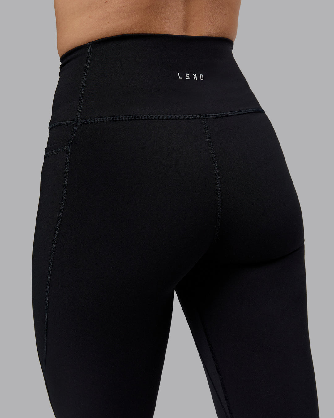 Woman wearing Fusion Ultra High-Rise Flared Petite Legging Pockets - Black| Model:Bianca | Size:S