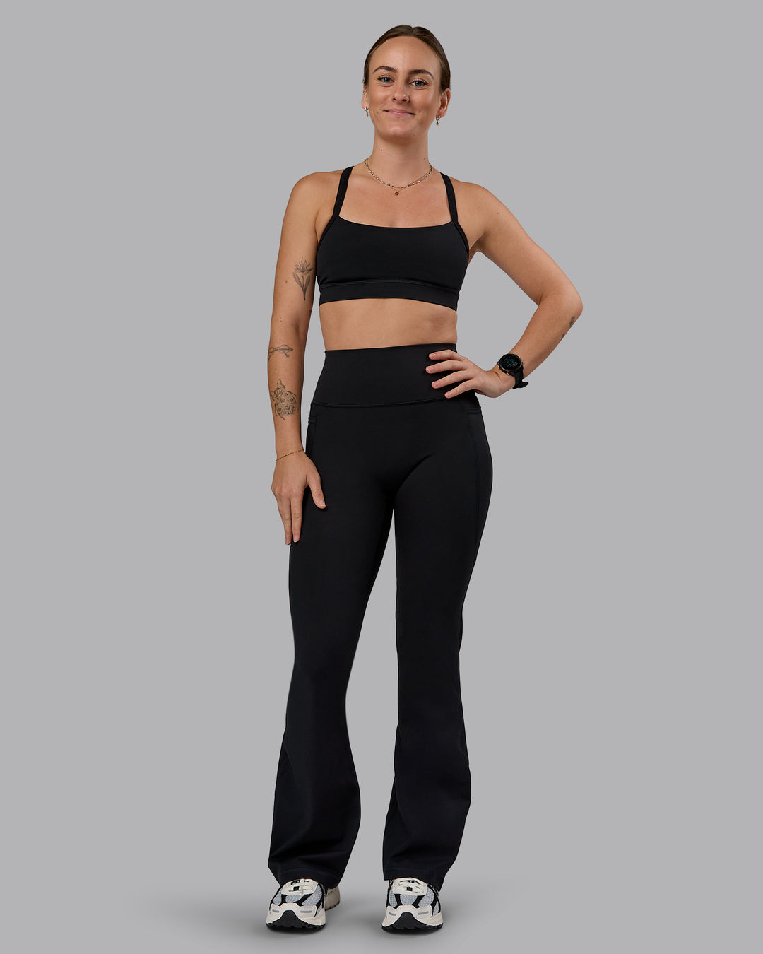 Woman wearing Fusion Ultra High-Rise Flared Petite Legging Pockets - Black| Model:Bianca | Size:S