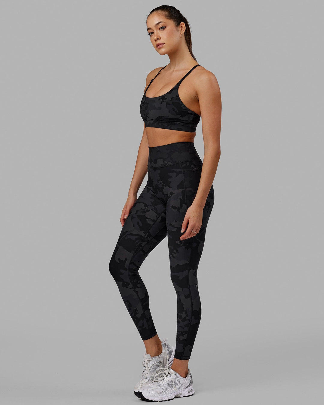 Woman wearing Fusion Ultra High-Rise Full Length Legging Pockets - Black Camo | Model:Katie | Size:S
