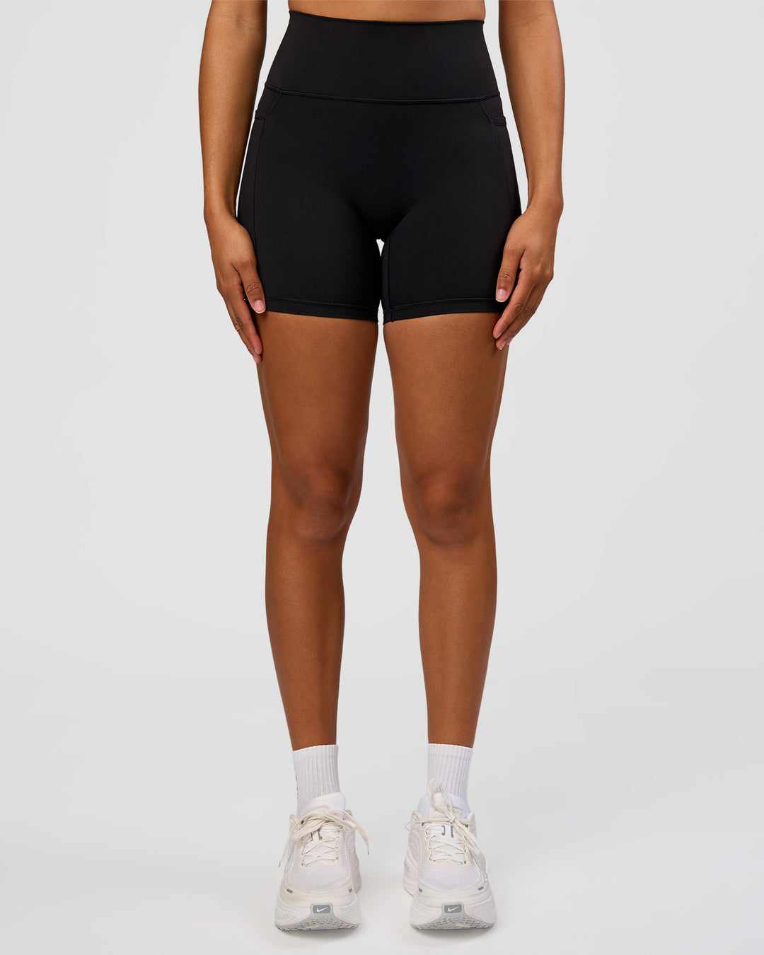 Woman wearing Fusion Graphic Ultra High-Rise 6" Short Pockets - Black-Radiate | Model:Rosie | Size:S