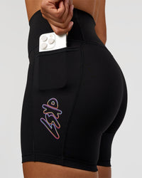 Woman wearing Fusion Graphic Ultra High-Rise 6" Short Pockets - Black-Radiate | Model:Rosie | Size:S