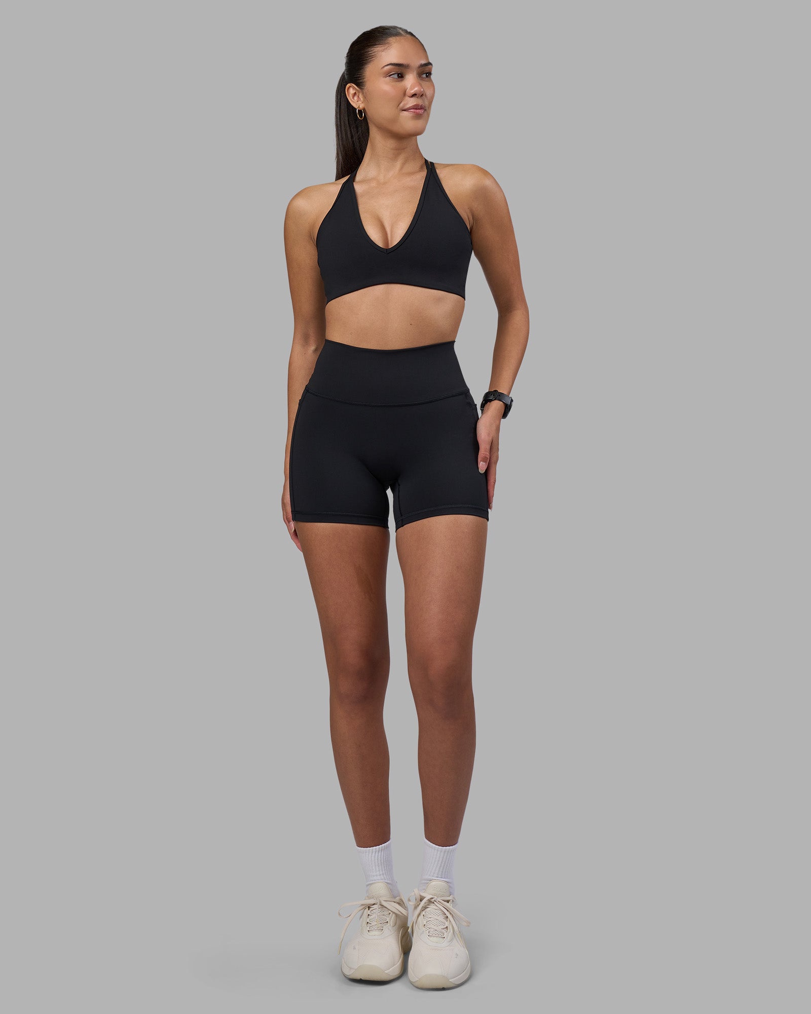 Woman wearing Fusion High-Rise 4" Short Pockets - Black | Model:Rhiley | Size:S