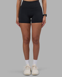 Woman wearing Fusion High-Rise 4" Short Pockets - Black | Model:Rhiley | Size:S