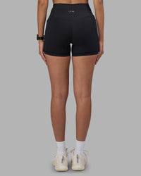 Woman wearing Fusion High-Rise 4" Short Pockets - Black | Model:Rhiley | Size:S
