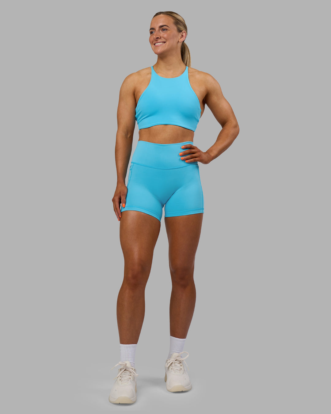 Woman wearing Fusion High-Rise 4&quot; Short Pockets - Blue Atoll | ModelGeorgia | Size:S