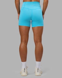 Woman wearing Fusion High-Rise 4" Short Pockets - Blue Atoll | ModelGeorgia | Size:S