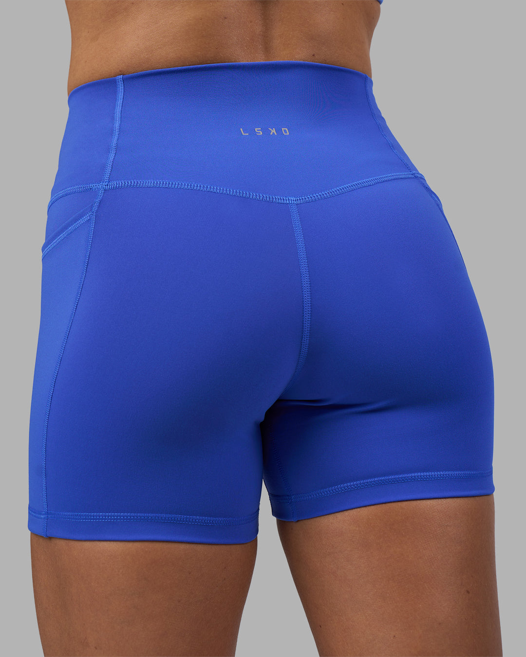 Woman wearing Fusion High-Rise 4&quot; Short Pockets - Power Cobalt | Model:Hannah | Size:S
