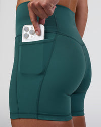 Woman wearing Fusion High-Rise 4" Short Pockets - Transformative Teal | Model:Sav | Size:S