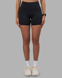 Woman wearing Fusion High-Rise 6" Short Pockets - Black | Model:Rhiley | Size:S