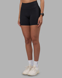 Woman wearing Fusion High-Rise 6" Short Pockets - Black | Model:Rhiley | Size:S