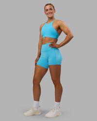 Woman wearing Fusion High-Rise 6" Short Pockets - Blue Atoll | Model:Georgia | Size:S