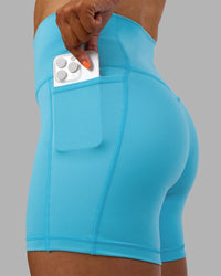 Woman wearing Fusion High-Rise 6" Short Pockets - Blue Atoll | Model:Georgia | Size:S