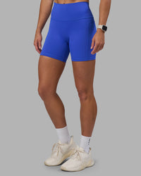 Woman wearing Fusion High-Rise 6" Short Pockets - Power Cobalt | Model:Hannah | Size:S