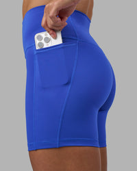 Woman wearing Fusion High-Rise 6" Short Pockets - Power Cobalt | Model:Hannah | Size:S