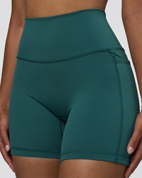 Woman wearing Fusion High-Rise 6" Short Pockets - Transformative Teal | Model:Jordan | Size:S