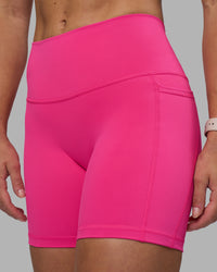 Woman wearing Fusion High-Rise 6" Short Pockets - Ultra Pink | Model:Hannah | Size:S