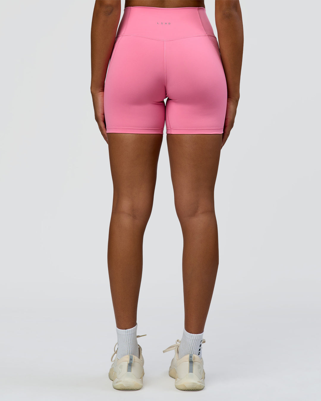Woman wearing Fusion High-Rise 6" Short Pockets - Candy Pink | Model:Rosie | Size:S