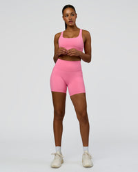 Woman wearing Fusion High-Rise 6" Short Pockets - Candy Pink | Model:Rosie | Size:S