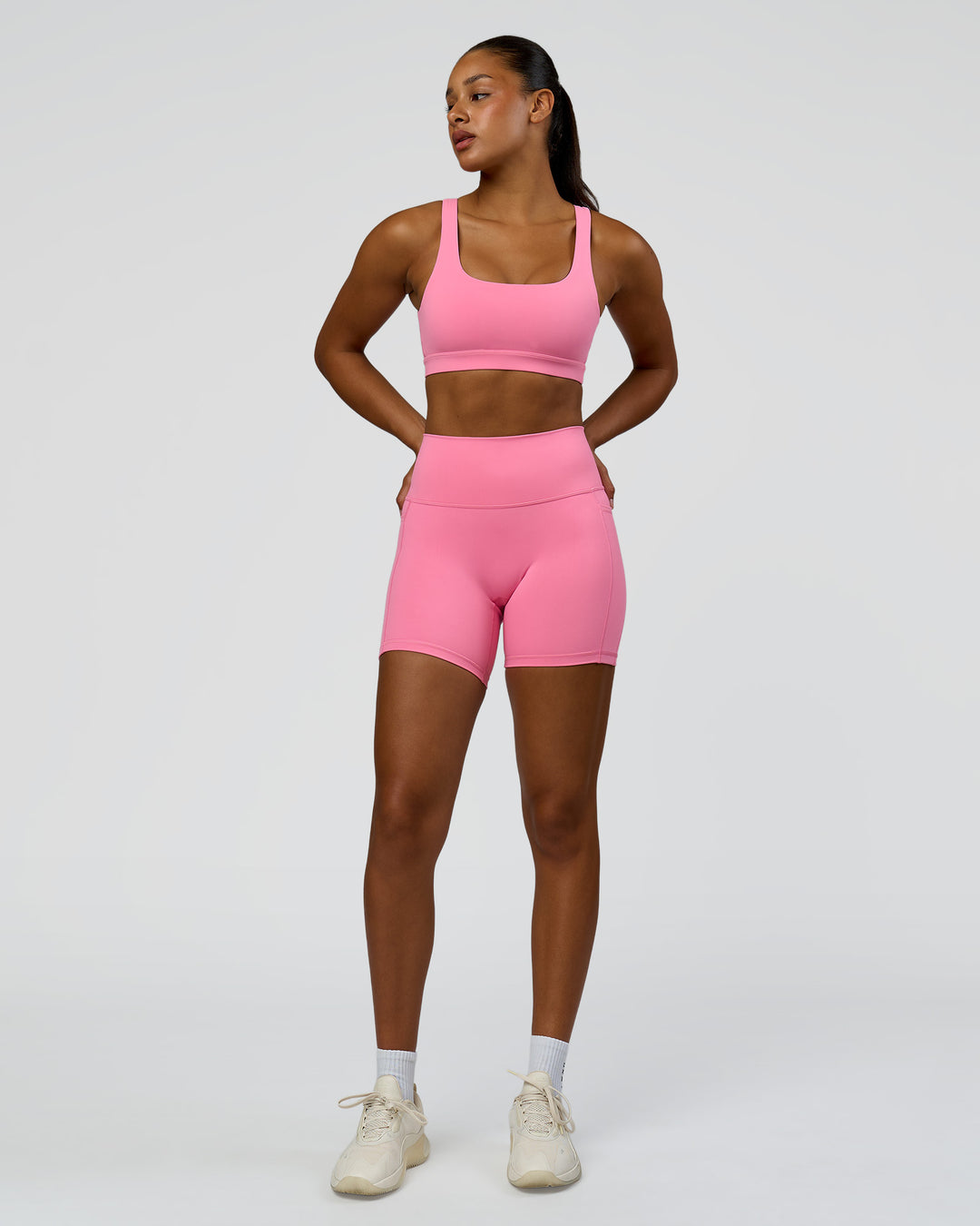 Woman wearing Fusion High-Rise 6" Short Pockets - Candy Pink | Model:Rosie | Size:S