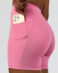 Woman wearing Fusion High-Rise 6" Short Pockets - Candy Pink | Model:Rosie | Size:S