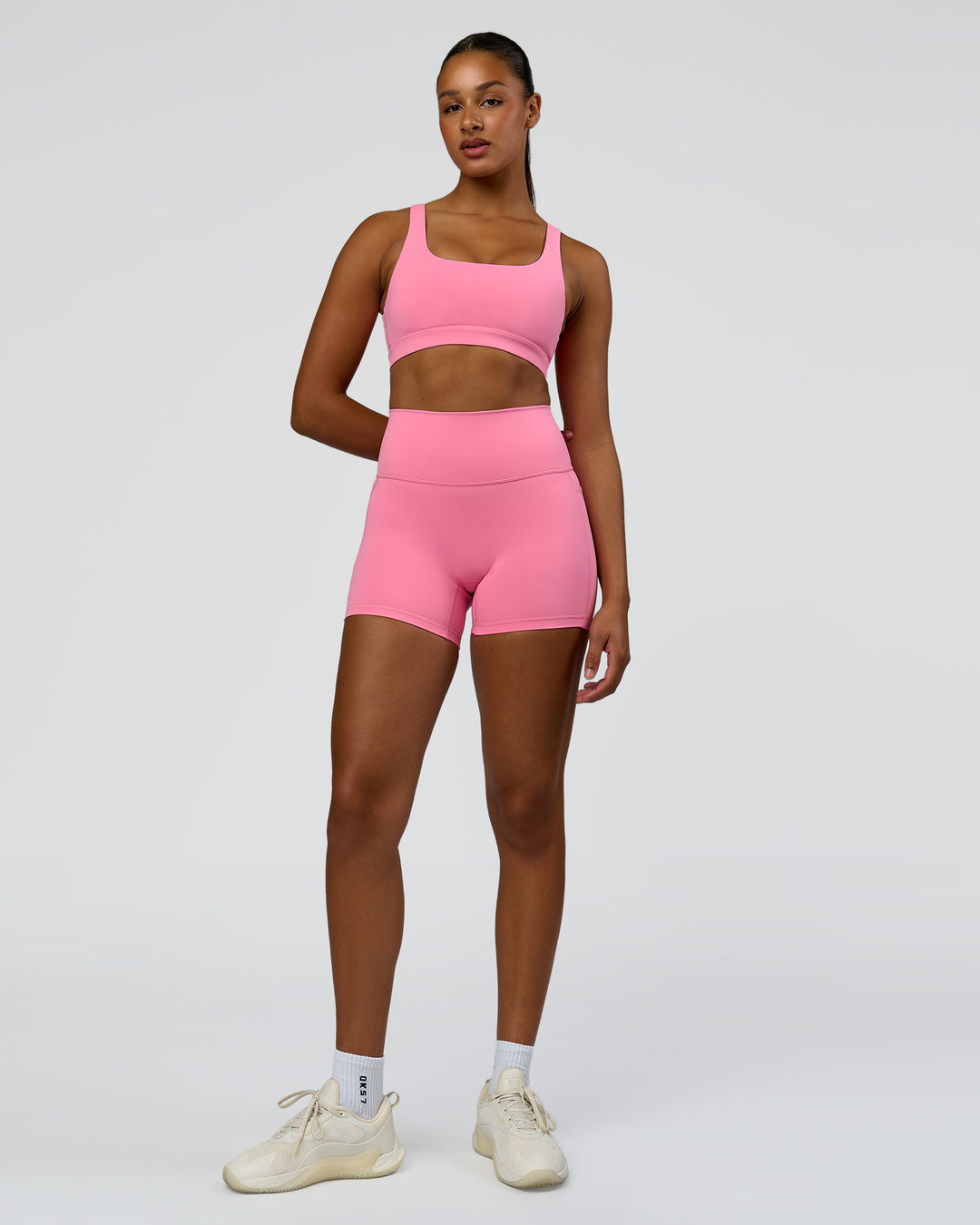 Woman wearing Fusion High-Rise 4" Short Pockets - Candy Pink | Model:Rosie | Size:S