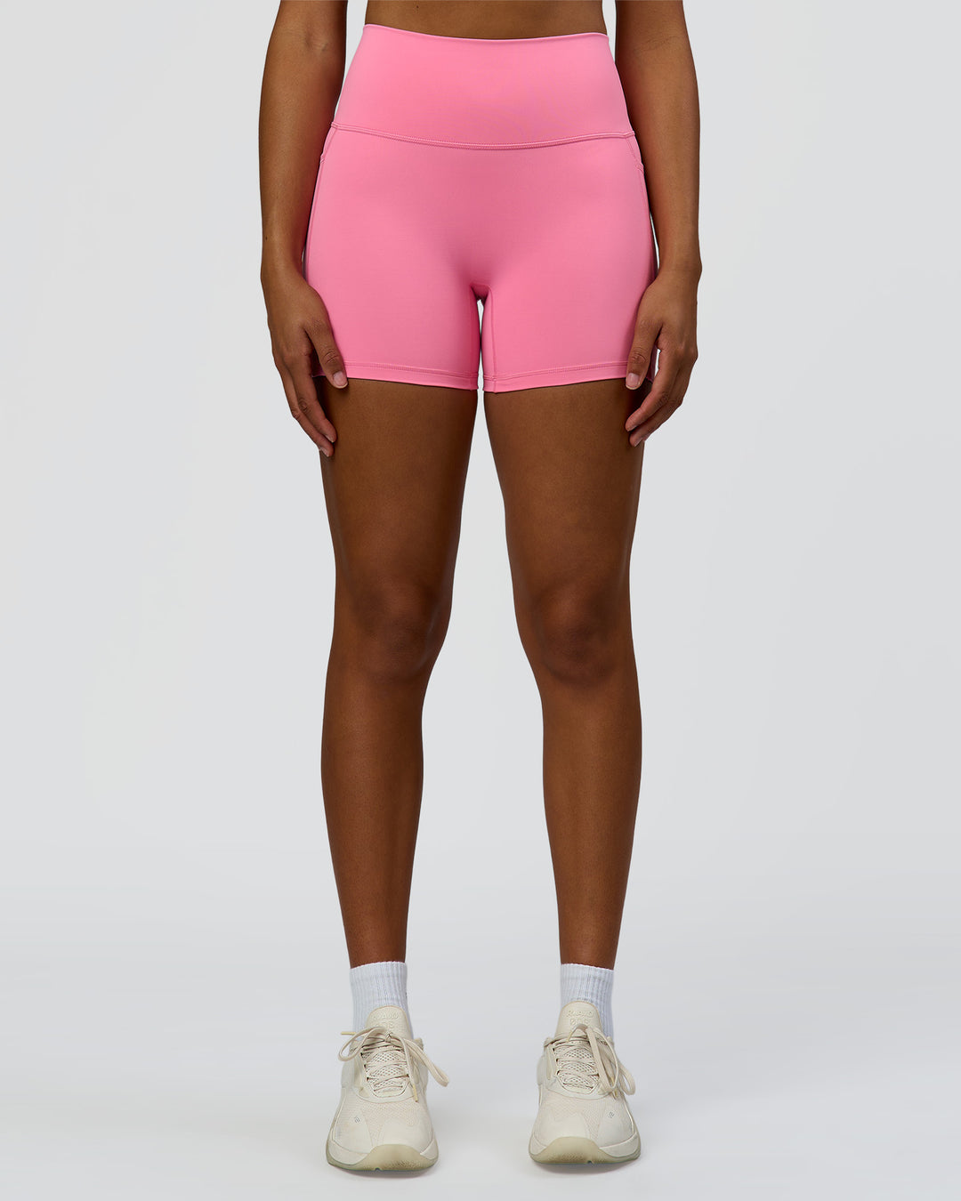 Woman wearing Fusion High-Rise 4" Short Pockets - Candy Pink | Model:Rosie | Size:S