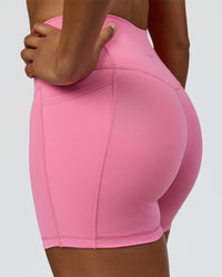 Woman wearing Fusion High-Rise 4" Short Pockets - Candy Pink | Model:Rosie | Size:S