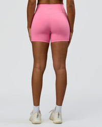 Woman wearing Fusion High-Rise 4" Short Pockets - Candy Pink | Model:Rosie | Size:S