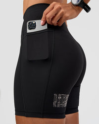 Woman wearing Fusion Hype Graphic Ultra High-Rise 6" Short Pockets - Black-Alloy | Model:Rhiley | Size:S