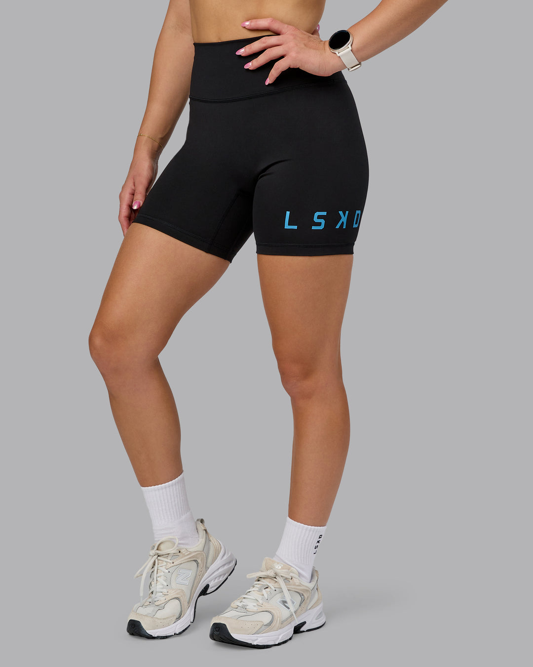 Woman wearing Fusion Ultra High-Rise 6&quot; Short Logo - Black-Azure Blue | Model:Halle | Size:S