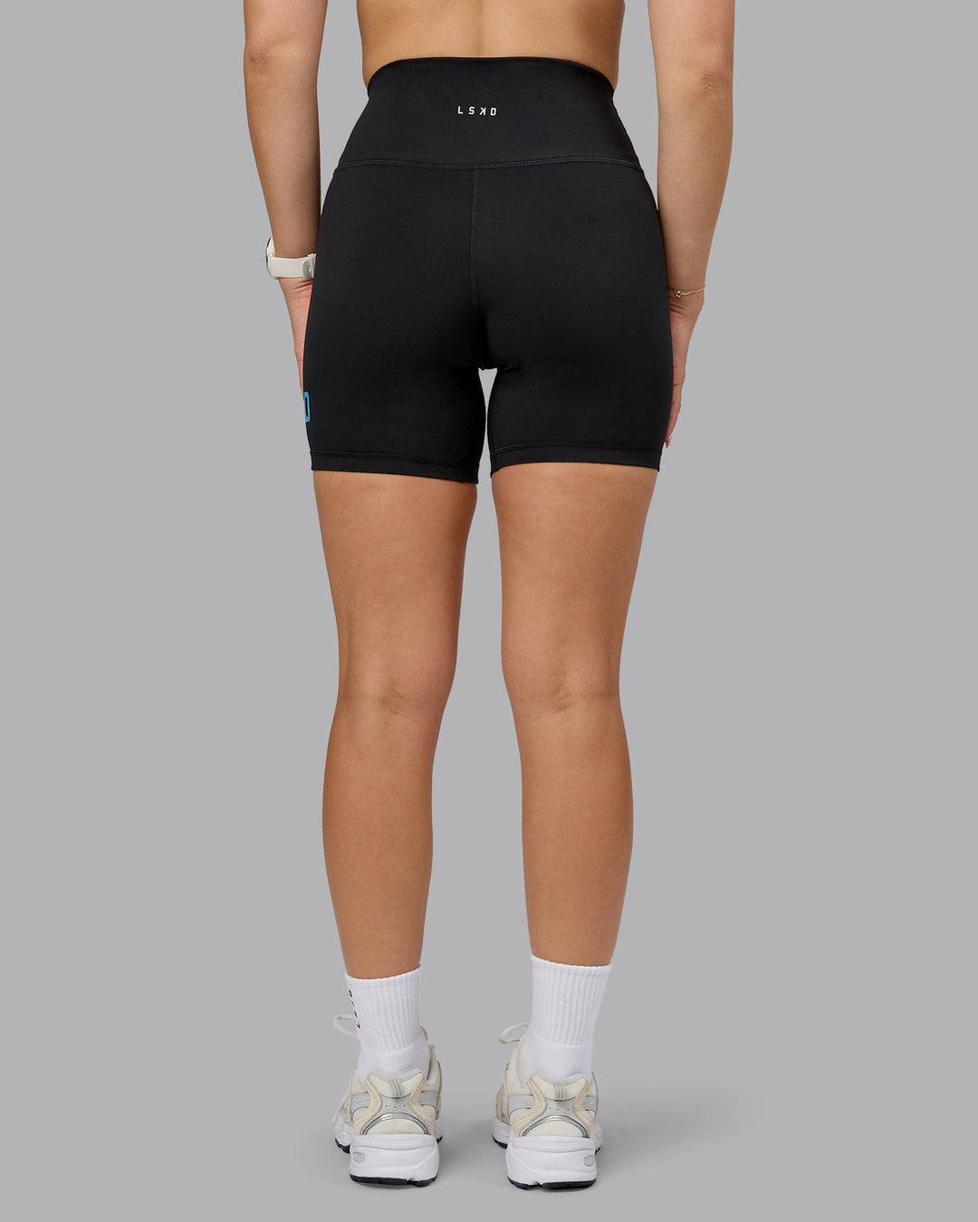 Woman wearing Fusion Ultra High-Rise 6&quot; Short Logo - Black-Azure Blue | Model:Halle | Size:S