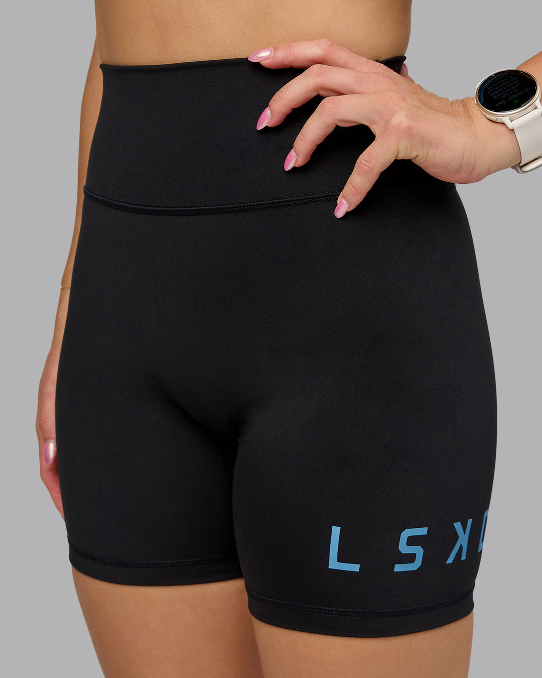 Woman wearing Fusion Ultra High-Rise 6&quot; Short Logo - Black-Azure Blue | Model:Halle | Size:S