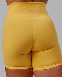 Woman wearing Fusion Ultra High-Rise 6" Short - Banana Cream | Model:Amber | Size:S