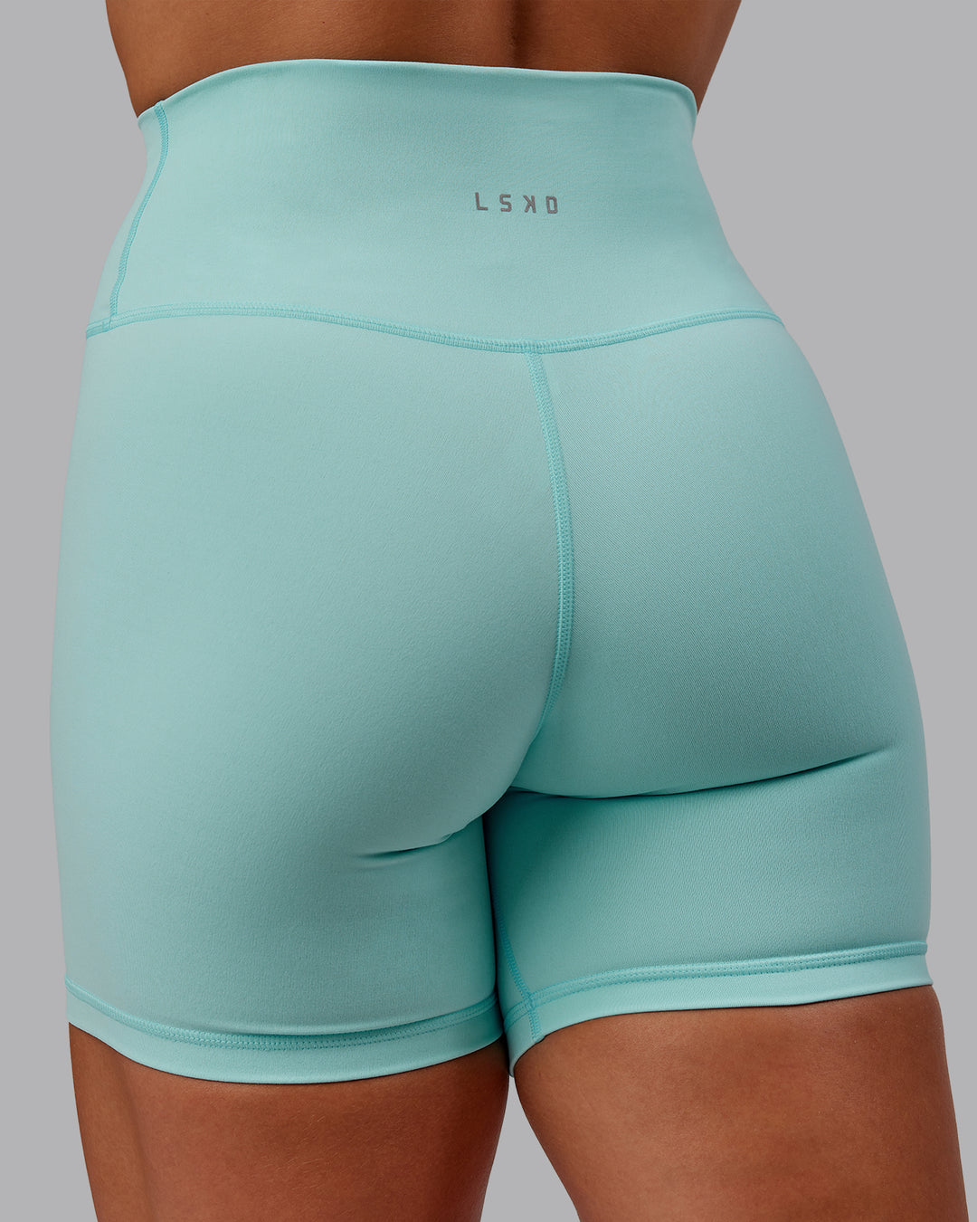 Woman wearing Fusion Ultra High-Rise 6&quot; Short - Island Paradise | Model:Amber | Size:S