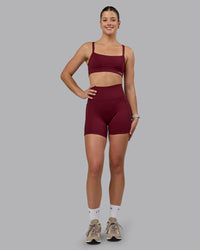 Woman wearing Fusion Ultra High-Rise 6" Short Pockets - Cordovan | Model:Chloe | Size:XS