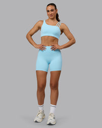 Woman wearing Fusion Ultra High-Rise 6" Short Pockets - Crystal Blue | Model:Sophie | Size:S