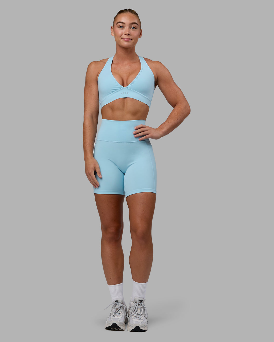 Woman wearing Fusion Ultra High-Rise 6&quot; Short Pockets - Glacial Blue | Model:Monique | Size:S
