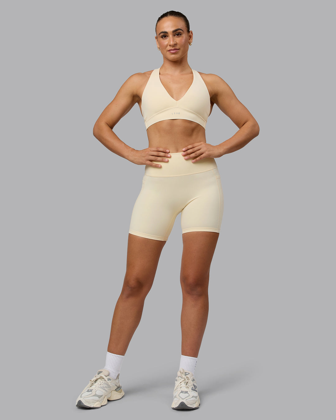 Woman wearing Fusion Ultra High-Rise 6&quot; Short Pockets - Ivory | Model:Sophie | Size:S