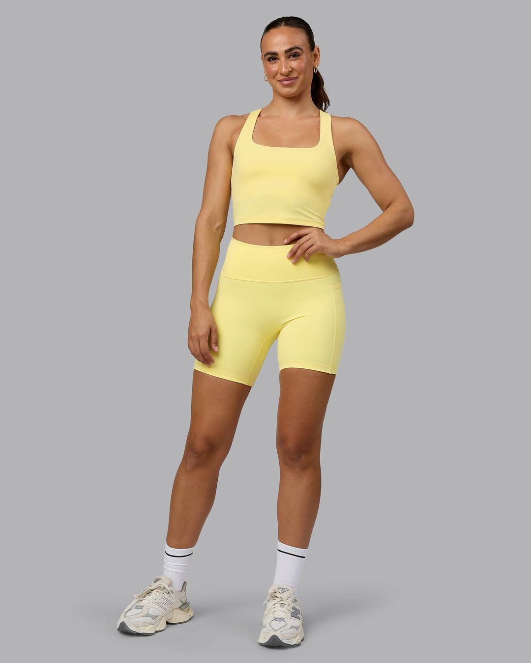 Woman wearing Fusion Ultra High-Rise 6&quot; Short Pockets - Lemon | Model:Sophie | Size:S
