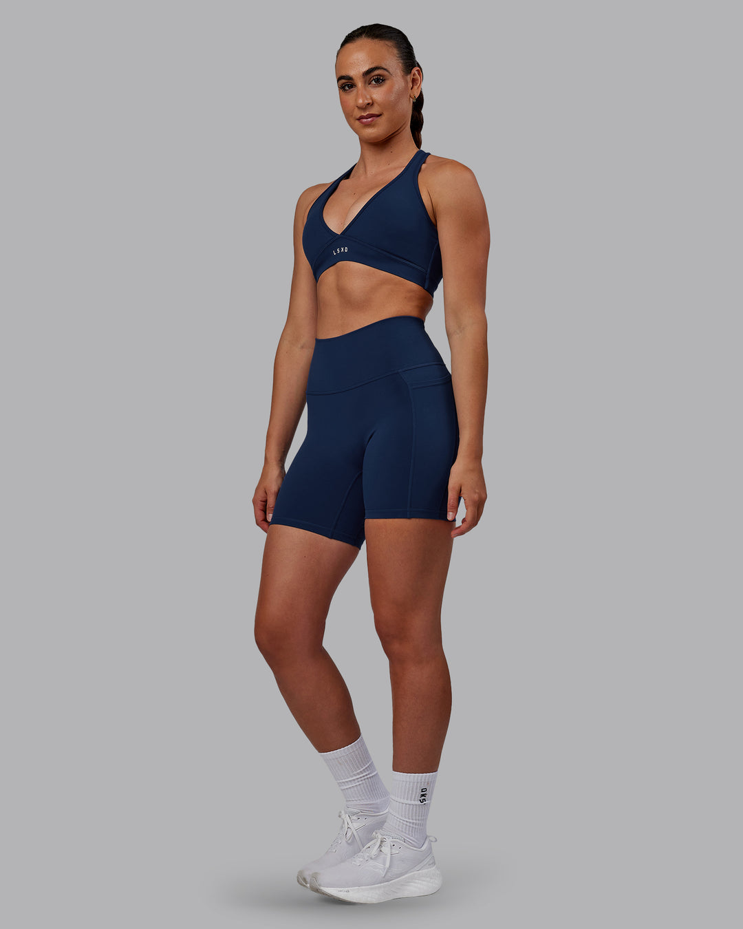 Woman wearing Fusion Ultra High-Rise 6&quot; Short Pockets - Future Navy | Model:Sophie | Size:S
