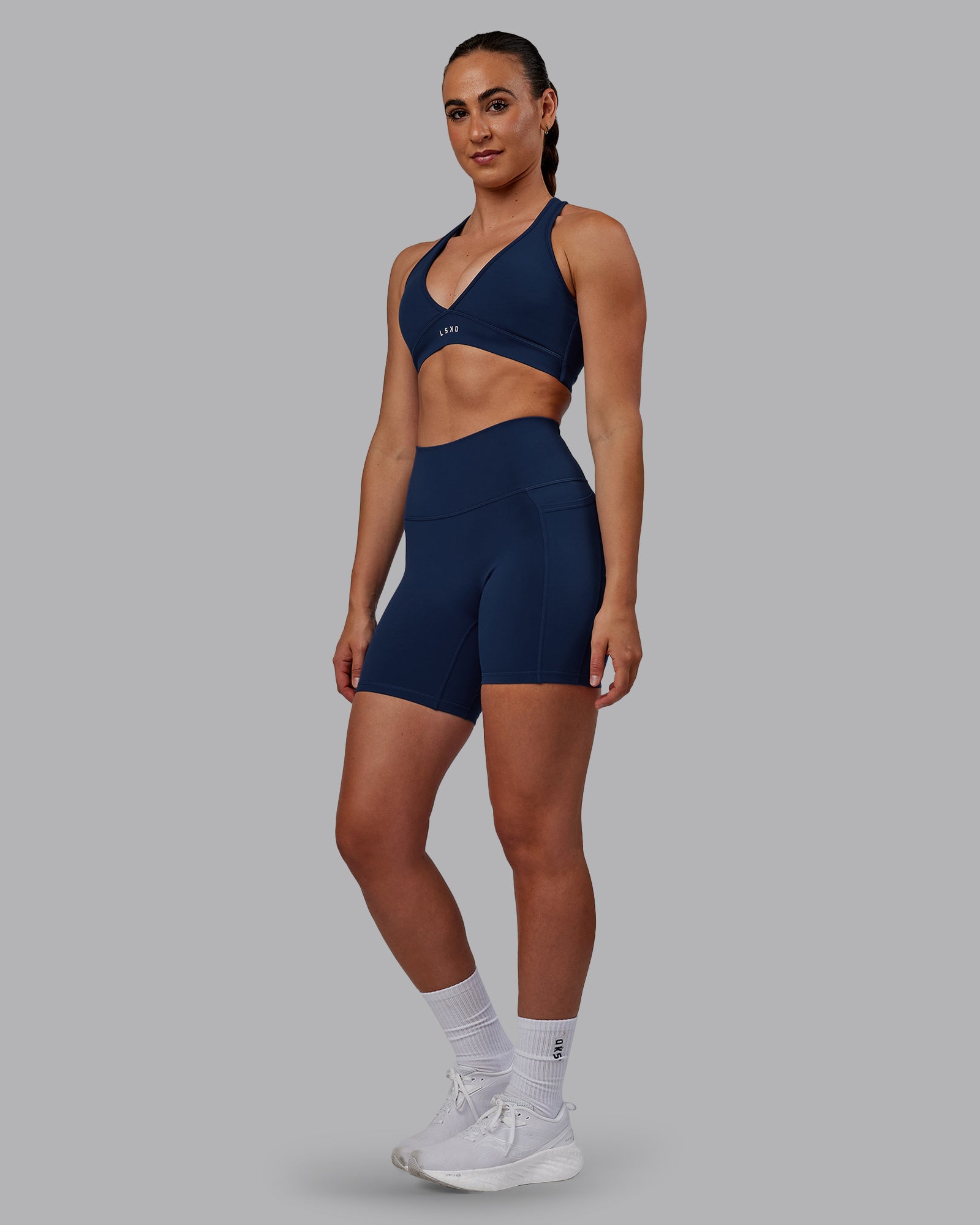 Woman wearing Fusion Ultra High-Rise 6" Short Pockets - Future Navy | Model:Sophie | Size:S