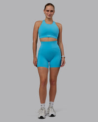 Woman wearing Fusion Ultra High-Rise 6" Short Pockets - Pacific Blue | Model:Lillie | Size:S