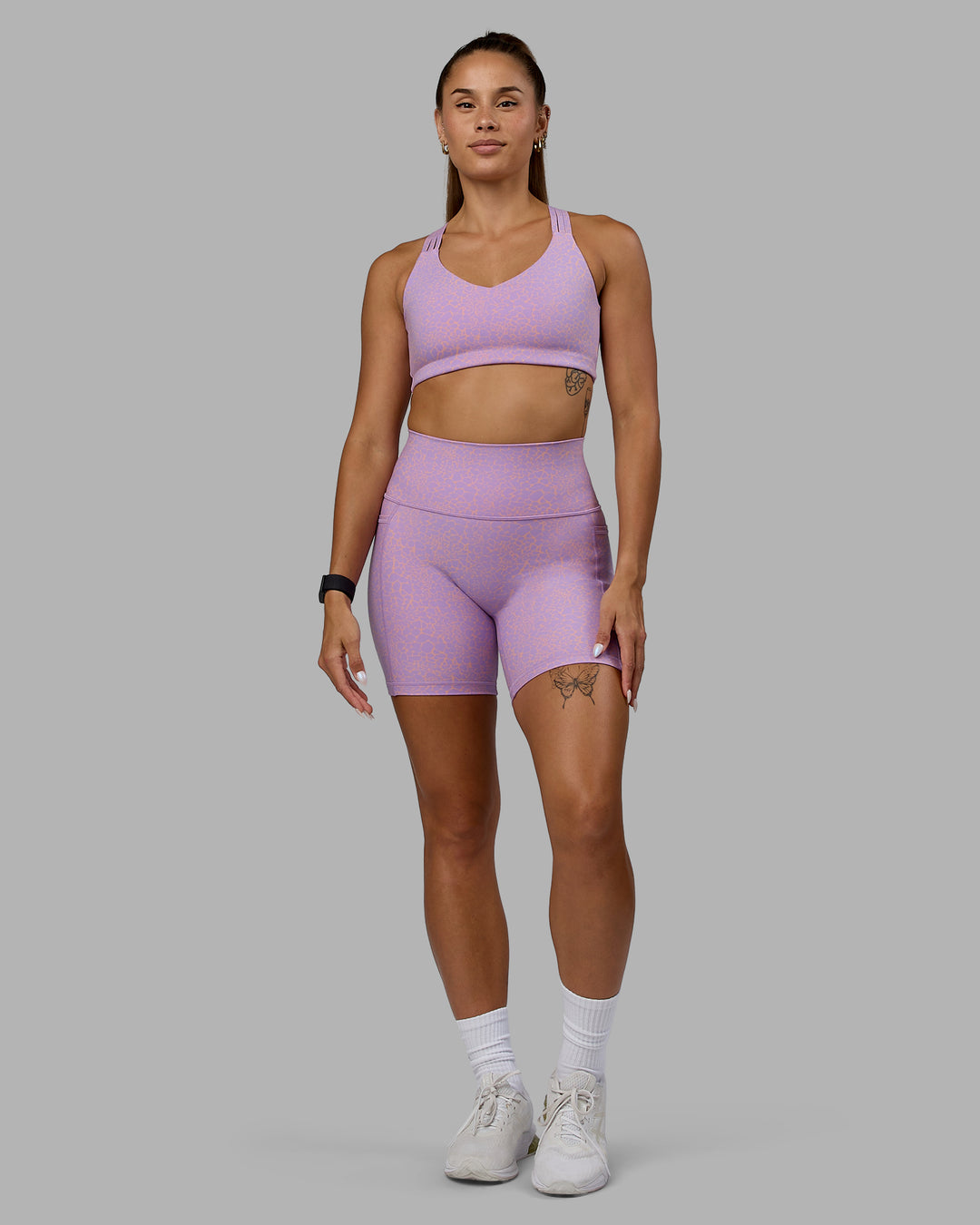 Woman wearing Fusion Ultra High-Rise 6&quot; Short Pockets - Pale Lilac Vitality Print | Model:Vanessa | Size:S