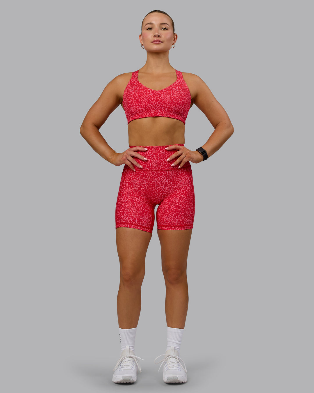 Woman wearing Fusion Ultra High-Rise 6&quot; Short Pockets - Red Vitality Print | Model:Halle | Size:S