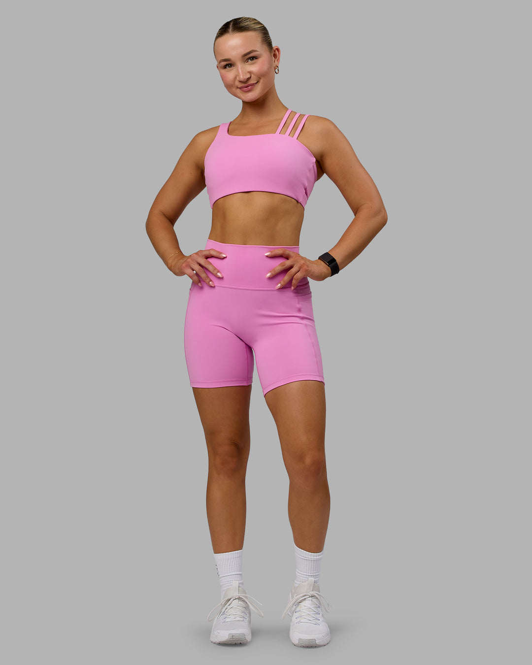 Woman wearing Fusion Ultra High-Rise 6" Short Pockets - Spark Pink | Model:Halle | Size:S