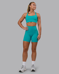Woman wearing Fusion Ultra High-Rise 6" Short Pockets - Uplift Blue | Model:Monique | Size:S