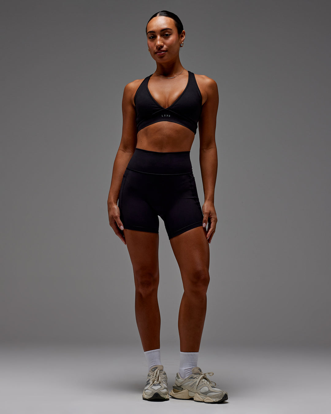 Woman wearing Fusion Ultra High-Rise 6&quot; Short Pockets - Black | Model:Demi | Size:S